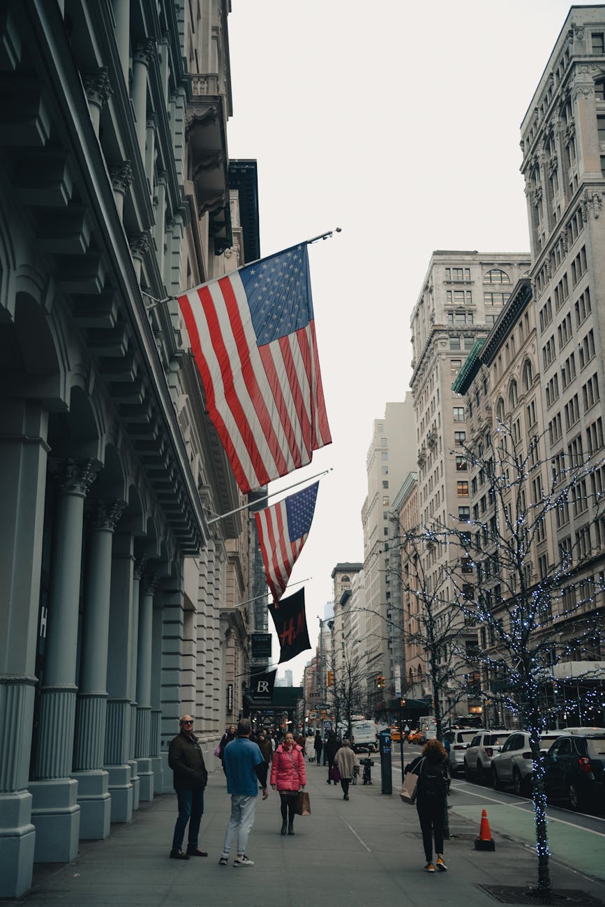 people walking on the sidewalk near the concrete buildings