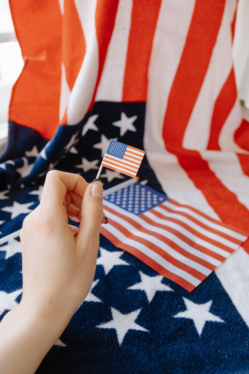 hand holding miniature of american flag
